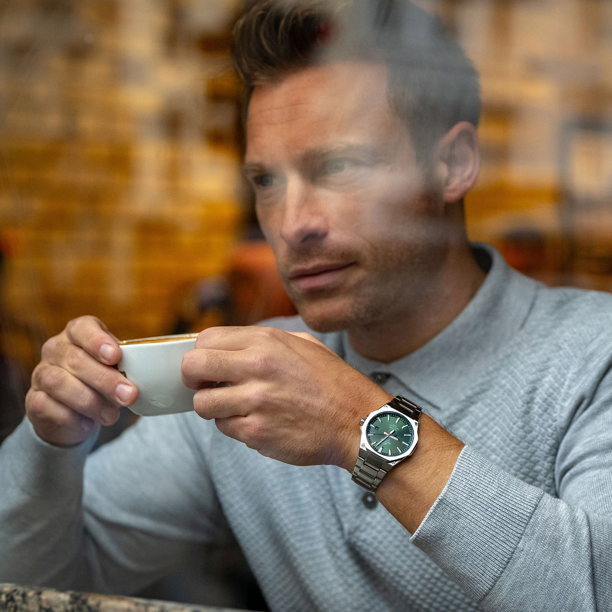 Lifestyle shot of a man wearing the Casio Edifice EFR-S108D-3AVUEF watch while holding a coffee cup