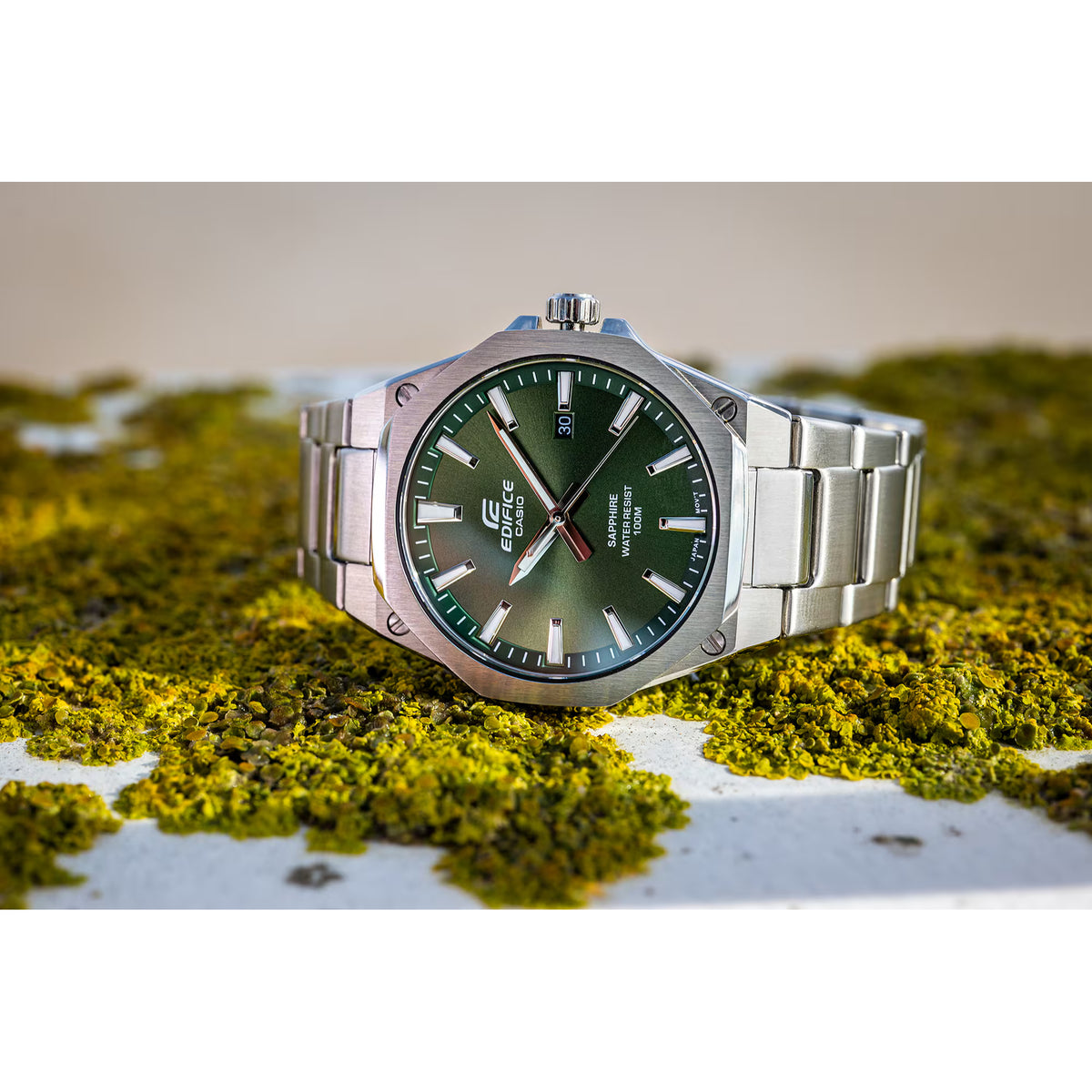 Angled lifestyle view of the Casio Edifice EFR-S108D-3AVUEF men's watch resting on a bed of natural moss