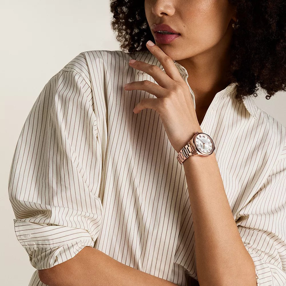 Lifestyle shot of a model wearing the Fossil Gilmore ES5394 timepiece styled with a striped shirt