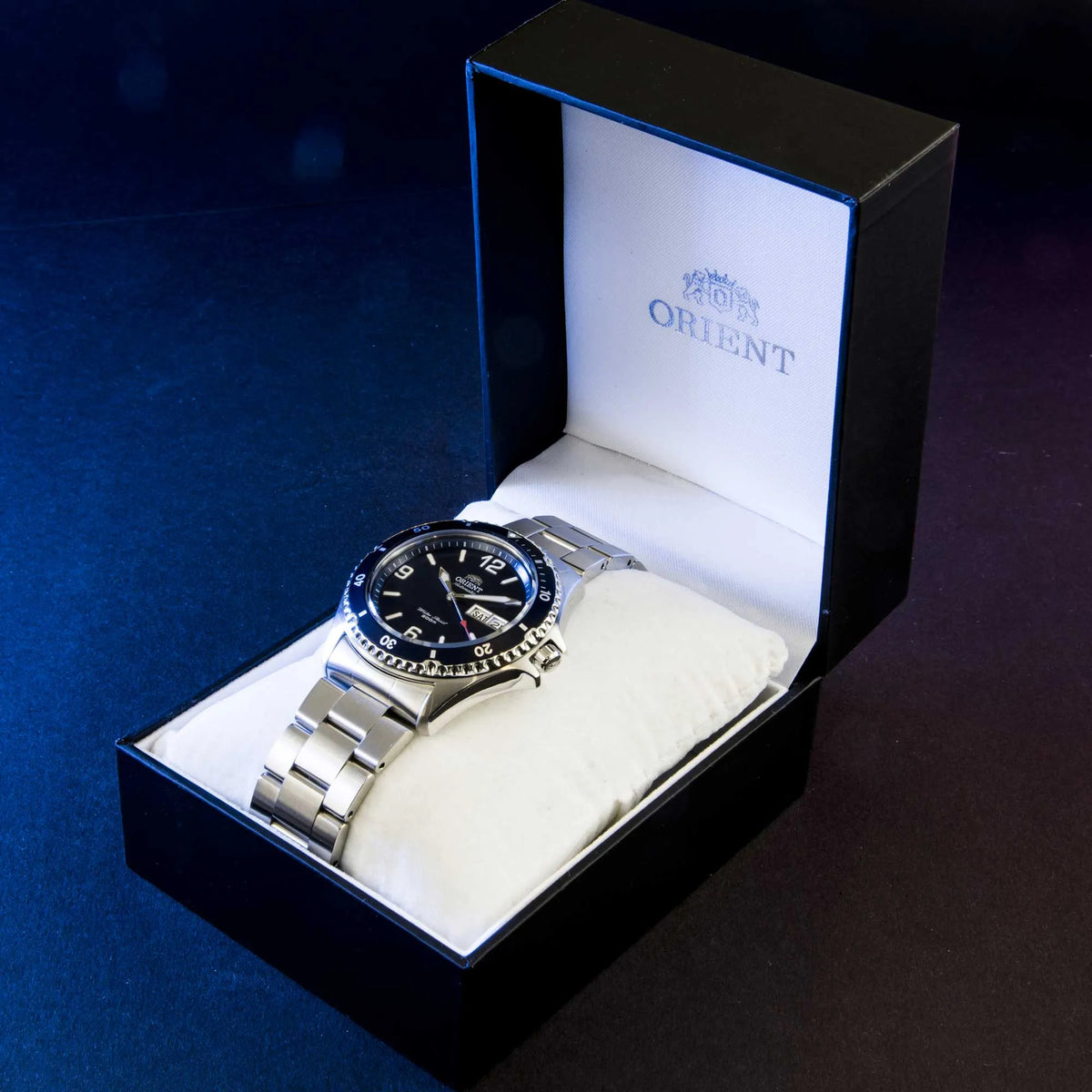 Men's automatic watch in presentation box with blue dial and steel bracelet on pillow