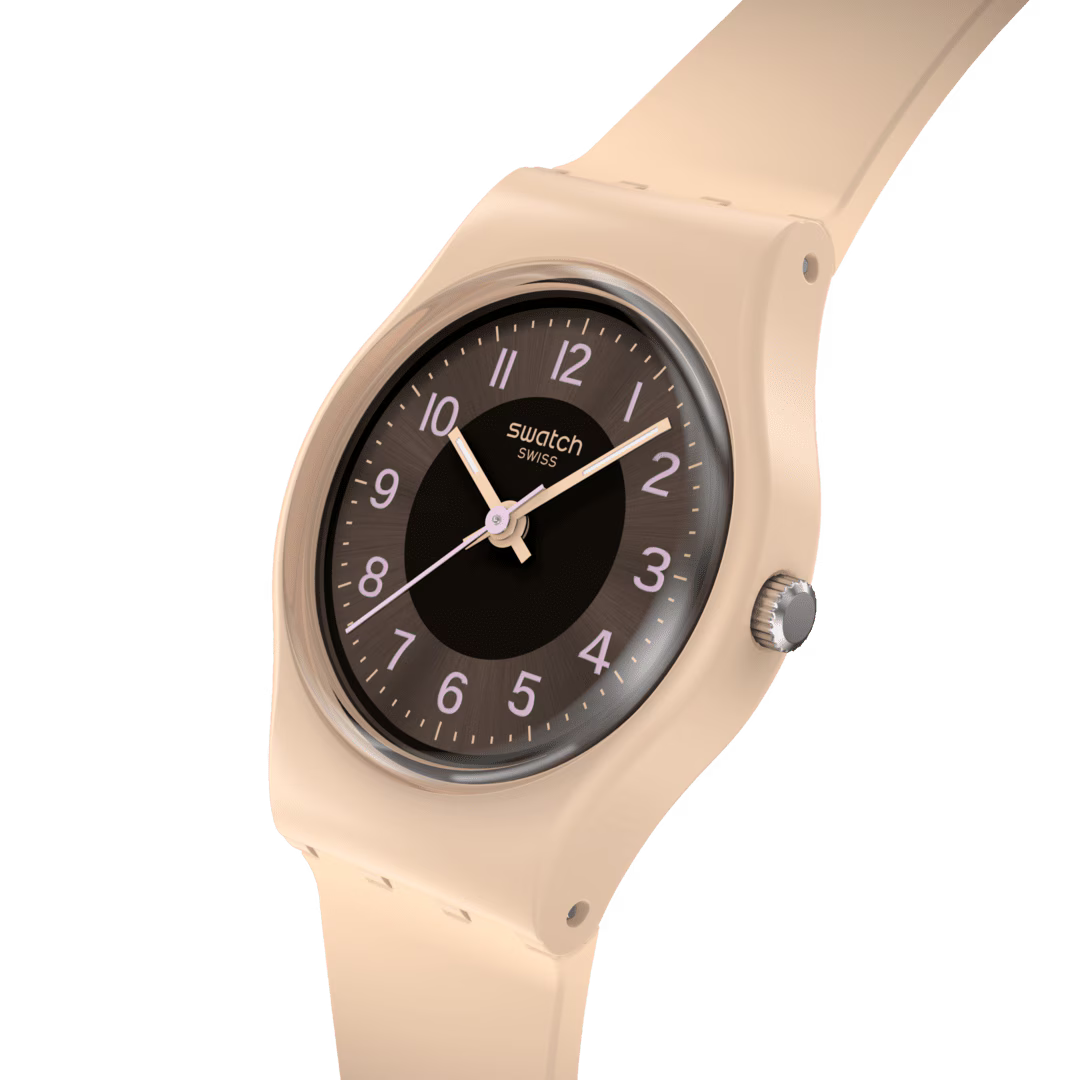 Swatch silicone strap watch close-up with dark brown dial and light pink hands