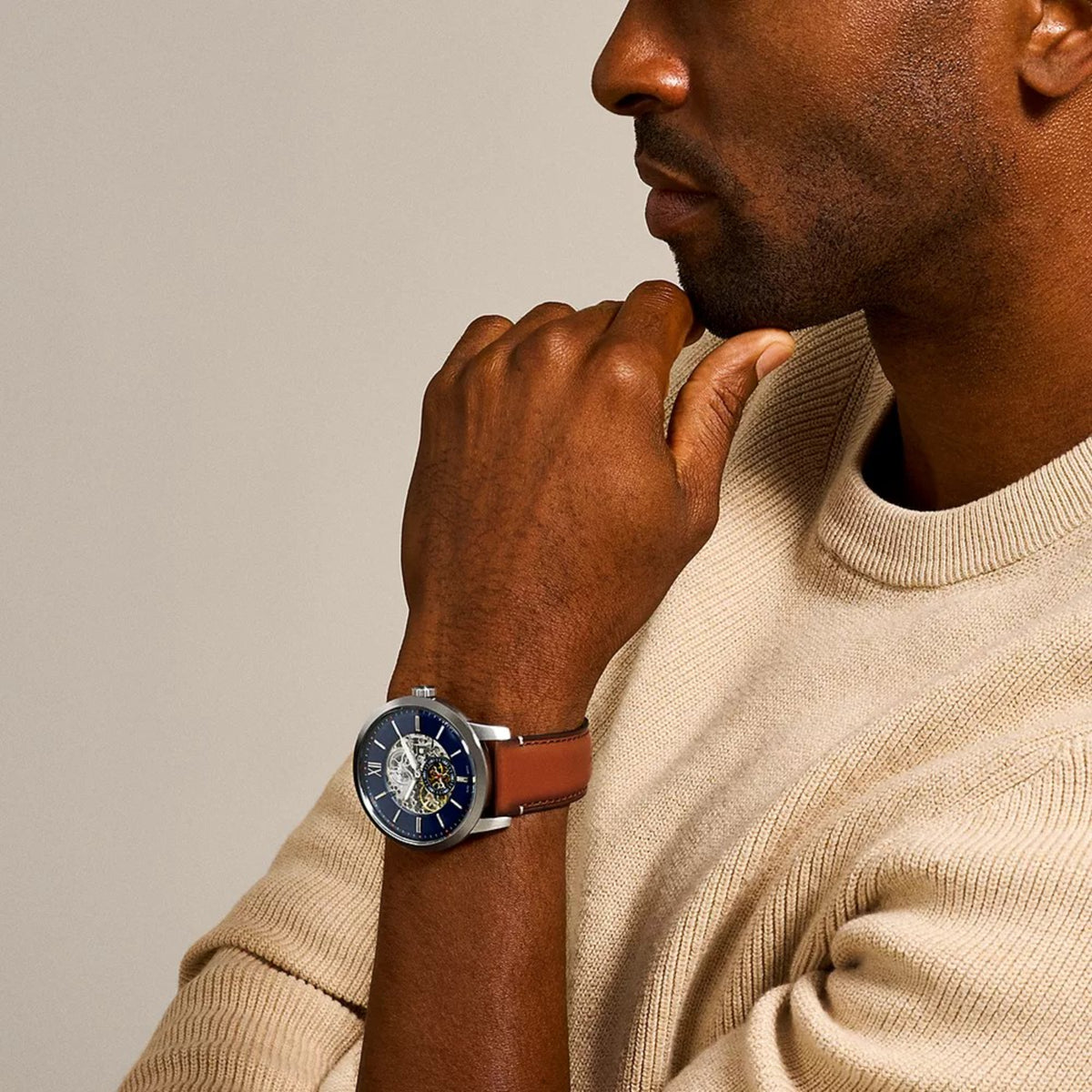Lifestyle perspective of the Fossil Townsman ME3154 mens watch displaying the blue dial and brown leather strap on a wrist
