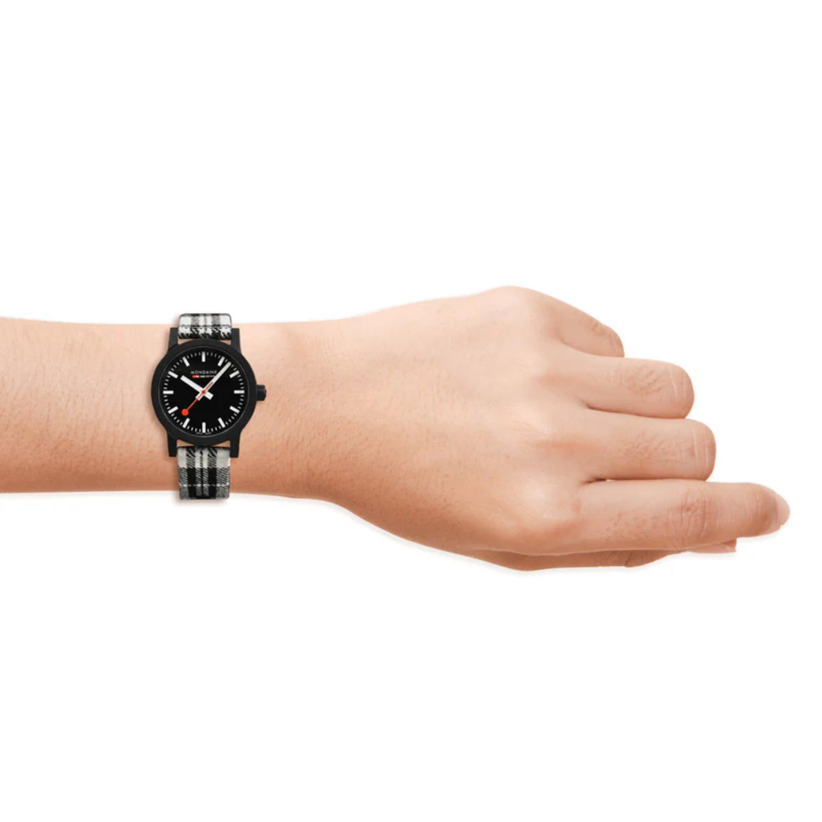 Ladies quartz wristwatch worn on wrist with black dial and black-and-white tartan strap