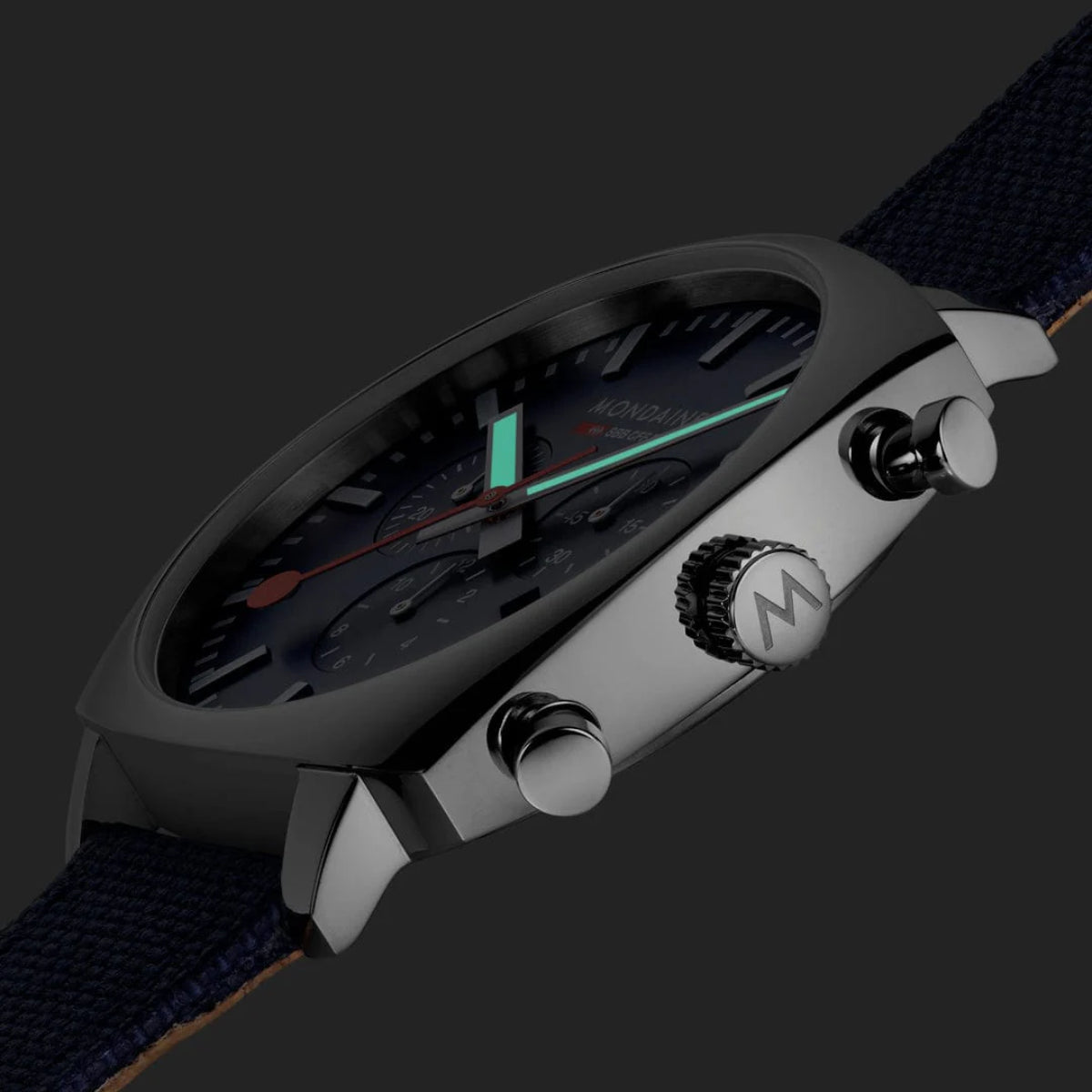 Side view of square watch with navy textile strap, silver case, and pushers