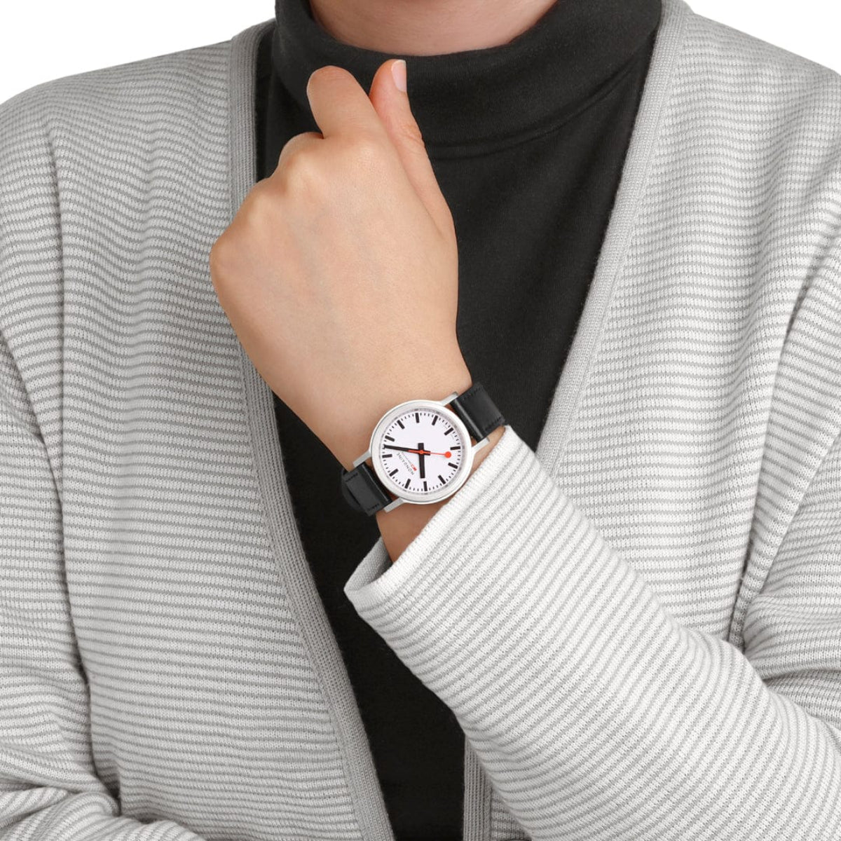 Mondaine quartz watch worn on wrist with black leather strap and white dial