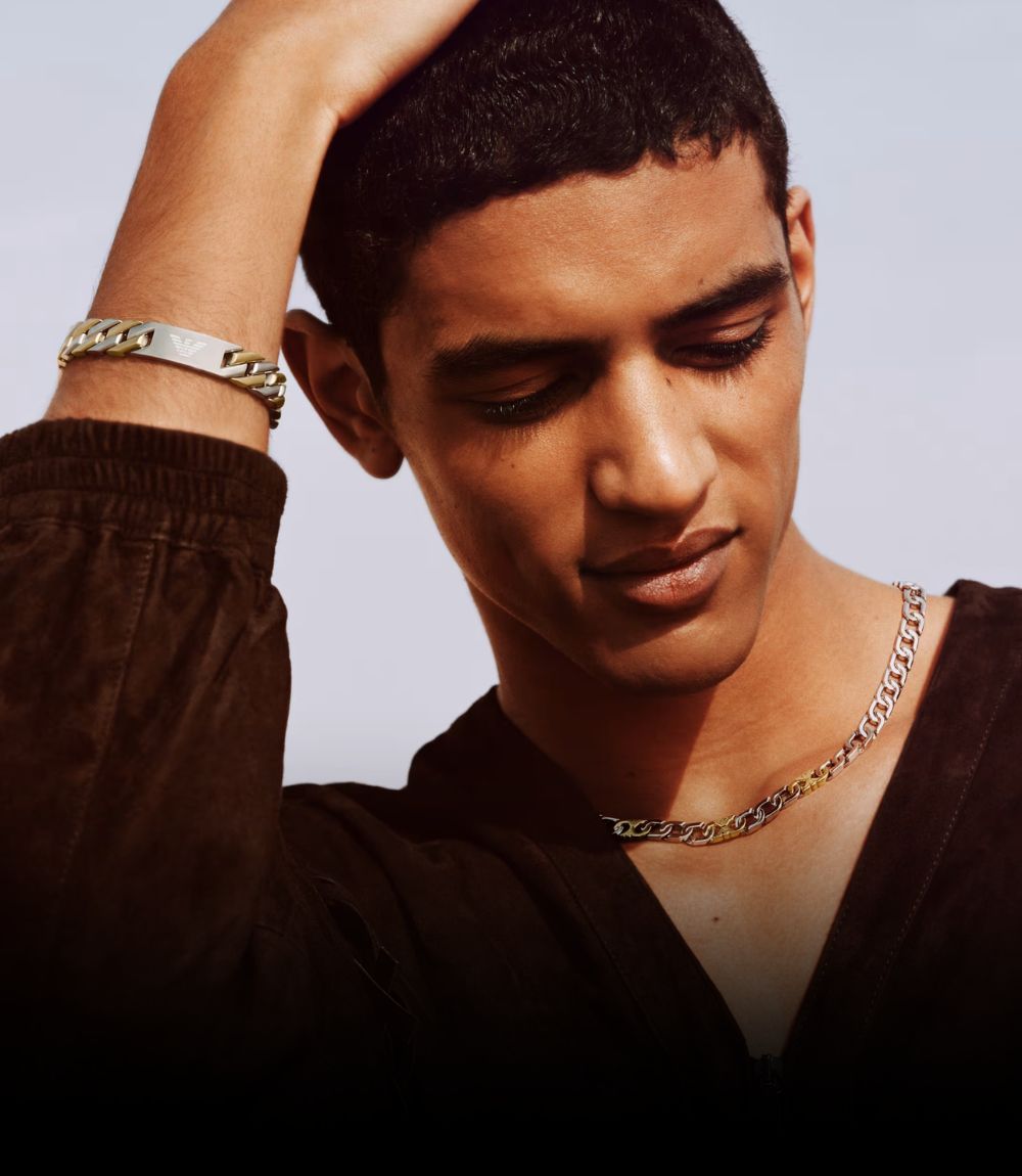 A man wearing Emporio Armani necklace and bracelet