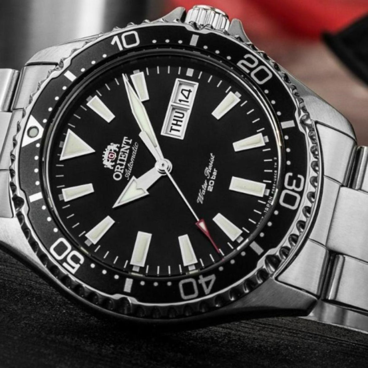 Close-up detail of the black dial, rotating dive bezel, and day-date window on the Orient Mako RA-AA0001B39B stainless steel watch