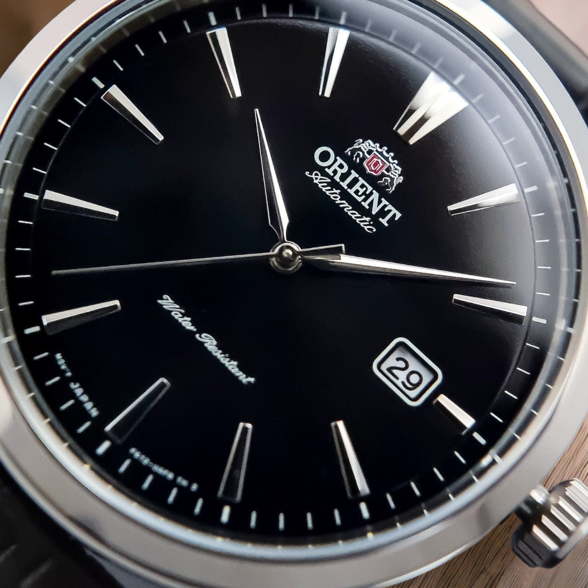 Orient Contemporary RA-AC0F05B30B watch with black dial and silver case on a wooden surface