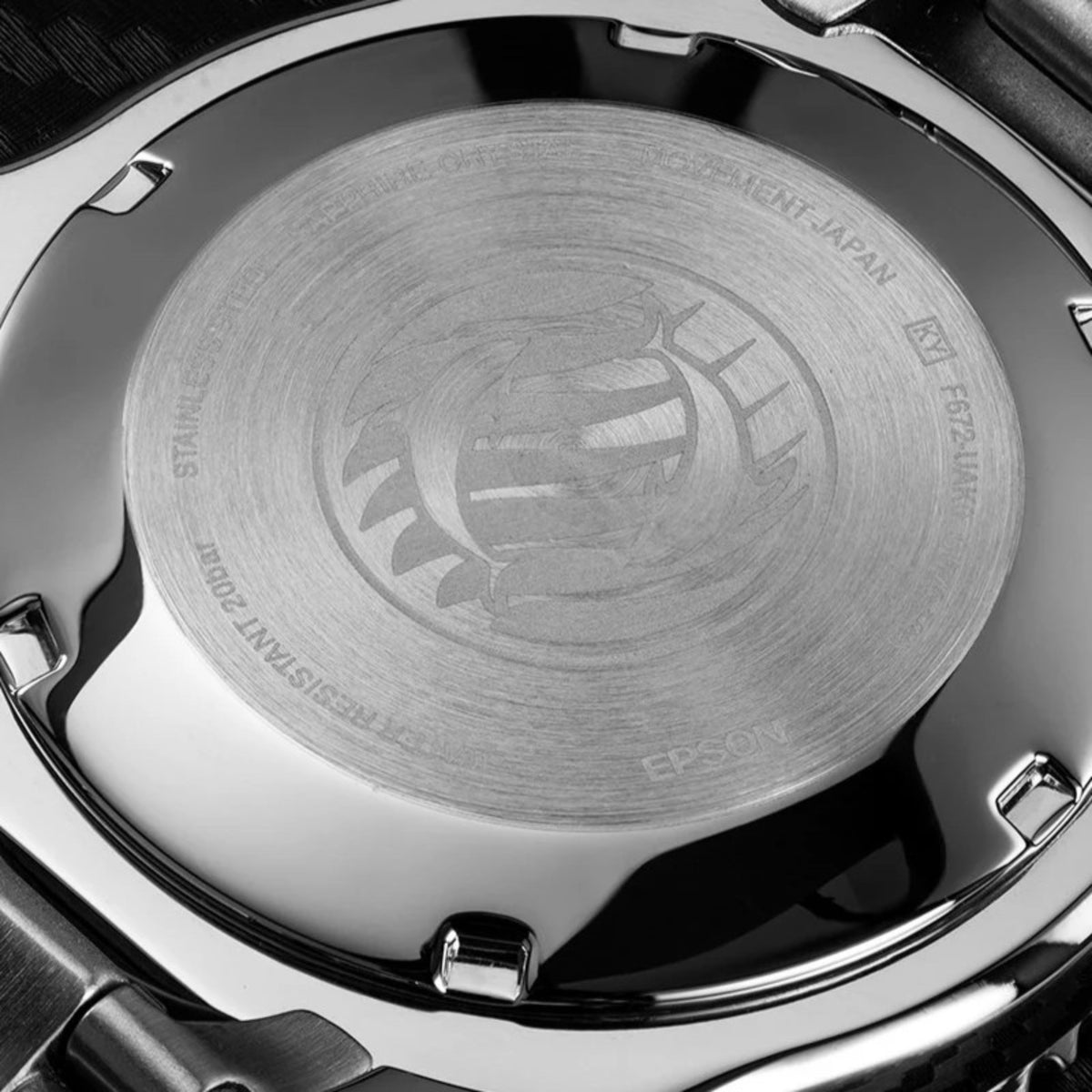 Steel watch caseback with engraved dragon logo and Orient Triton text