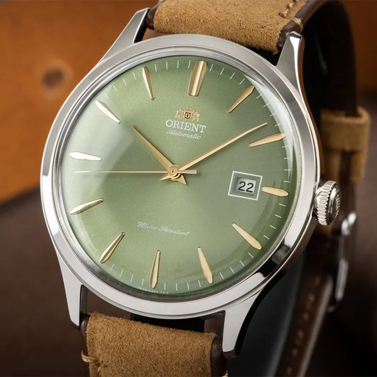 Orient Bambino RA-AC0P01E30B automatic timekeeper, highlighting a polished steel bezel and brown strap