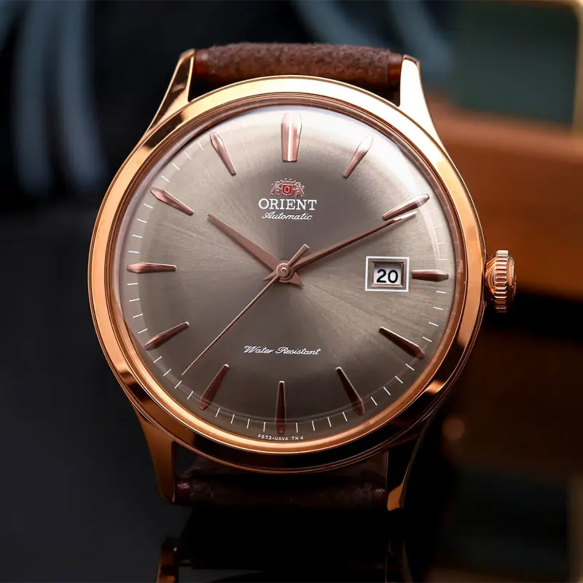 Orient Bambino RA-AC0P04Y30B close-up view of bronze dial displaying date window and index markers