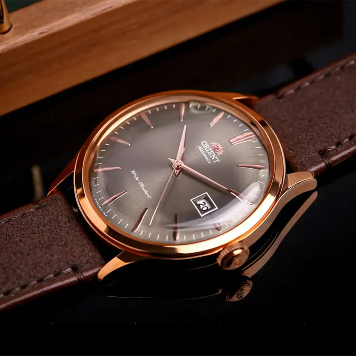 Orient Bambino RA-AC0P04Y30B angled view displaying bronze dial with domed crystal and leather strap