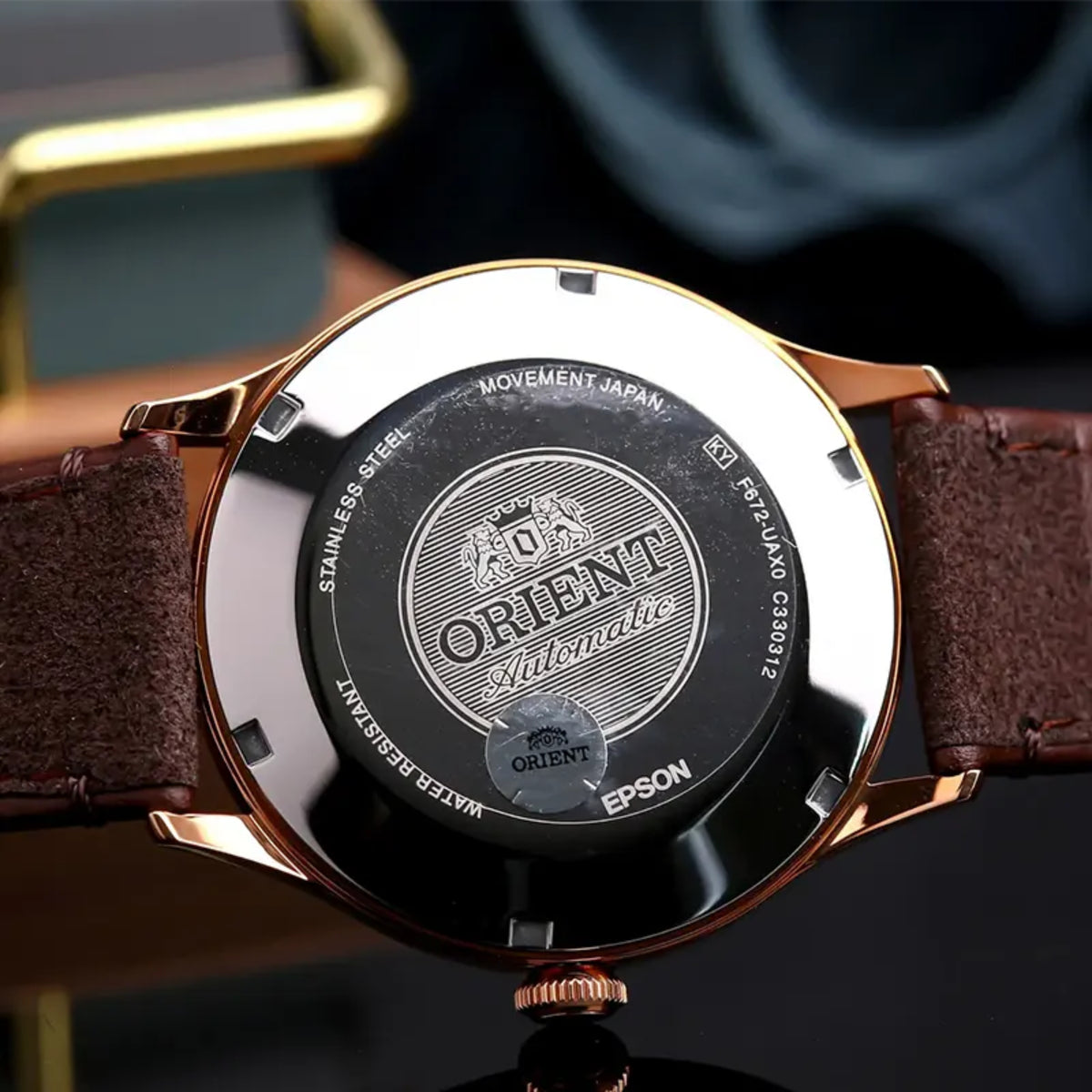 Orient Bambino RA-AC0P04Y30B back view showing stainless steel case back with engraved brand logo and leather strap texture