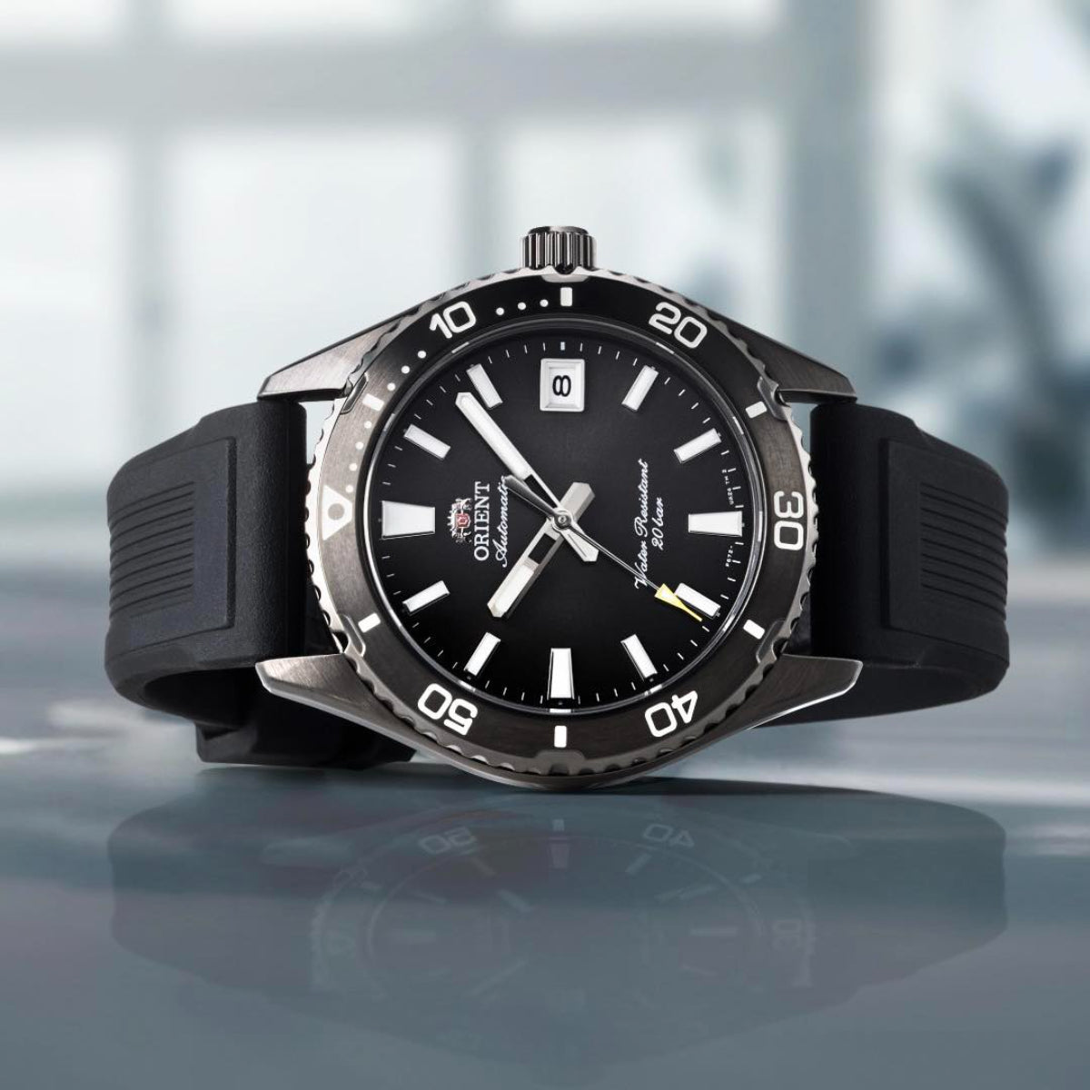 Front view of Orient Mako 40mm RA-AC0Q10N30B mens watch with black dial resting on a reflective surface