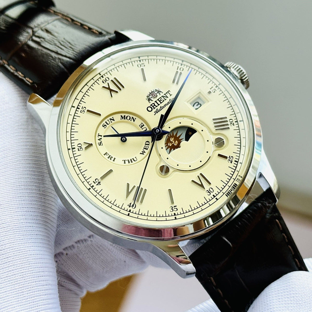 Orient Automatic Sun and Moon cream dial close up view