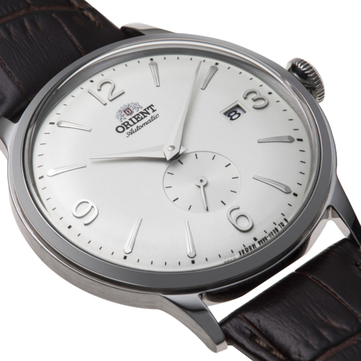 Men's automatic watch close-up: white dial with baton markers, brown leather strap