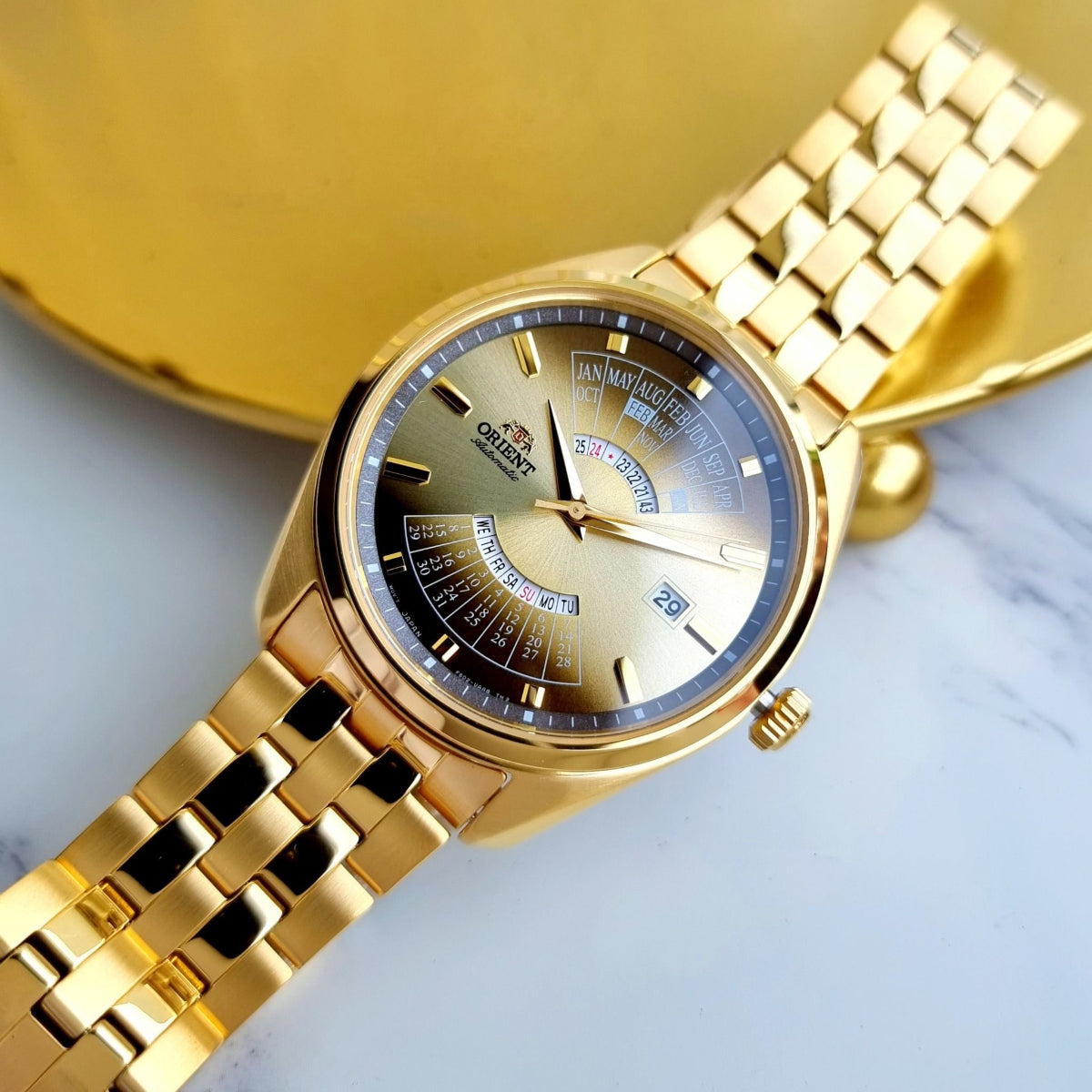 Orient Multi-Year Calendar RA-BA0001G30B automatic watch angled view, gold-tone steel bracelet, and gradient dial with date window