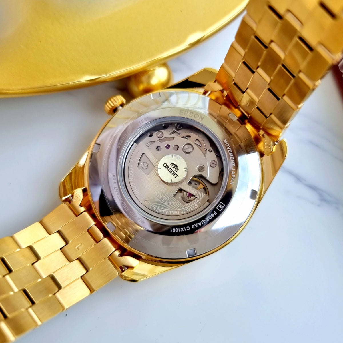 Orient Multi-Year Calendar RA-BA0001G30B watch, transparent back with gold-tone case and steel bracelet, movement visible