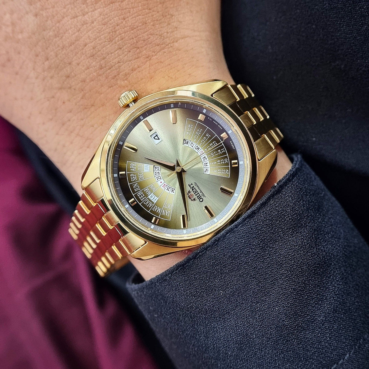 Mens Orient automatic watch RA-BA0001G30B on wrist, gold-tone case with gradient dial and date window