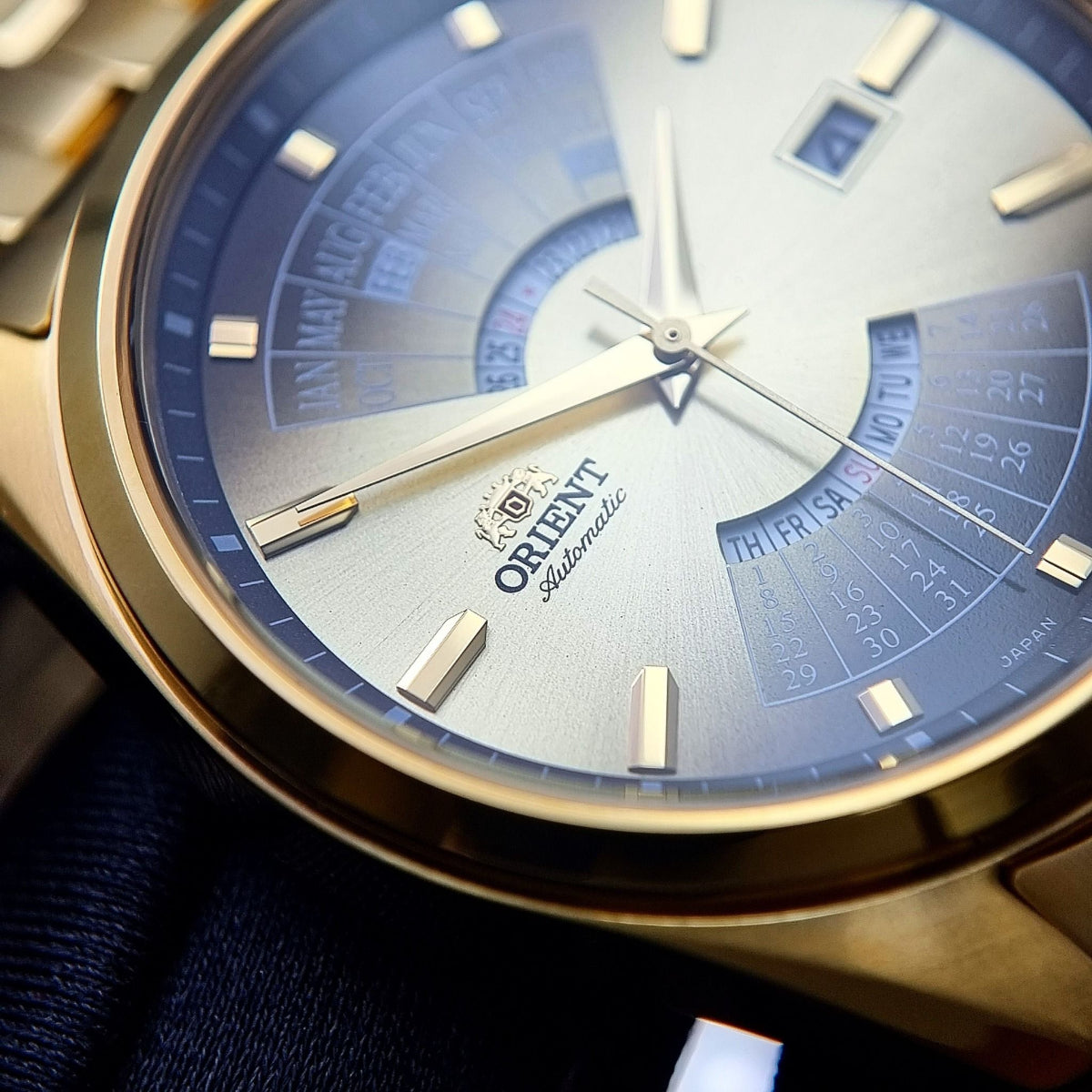Orient Multi-Year Calendar RA-BA0001G30B automatic watch close-up, gold bezel over blue gradient dial with calendar markings