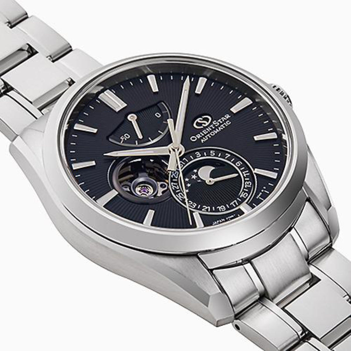 Close-up of steel automatic watch with dark blue dial, subdials, and moon phase