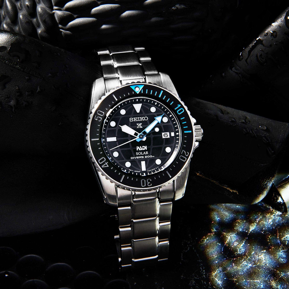 Men's stainless solar dive watch with black dial and blue bezel accents on bracelet