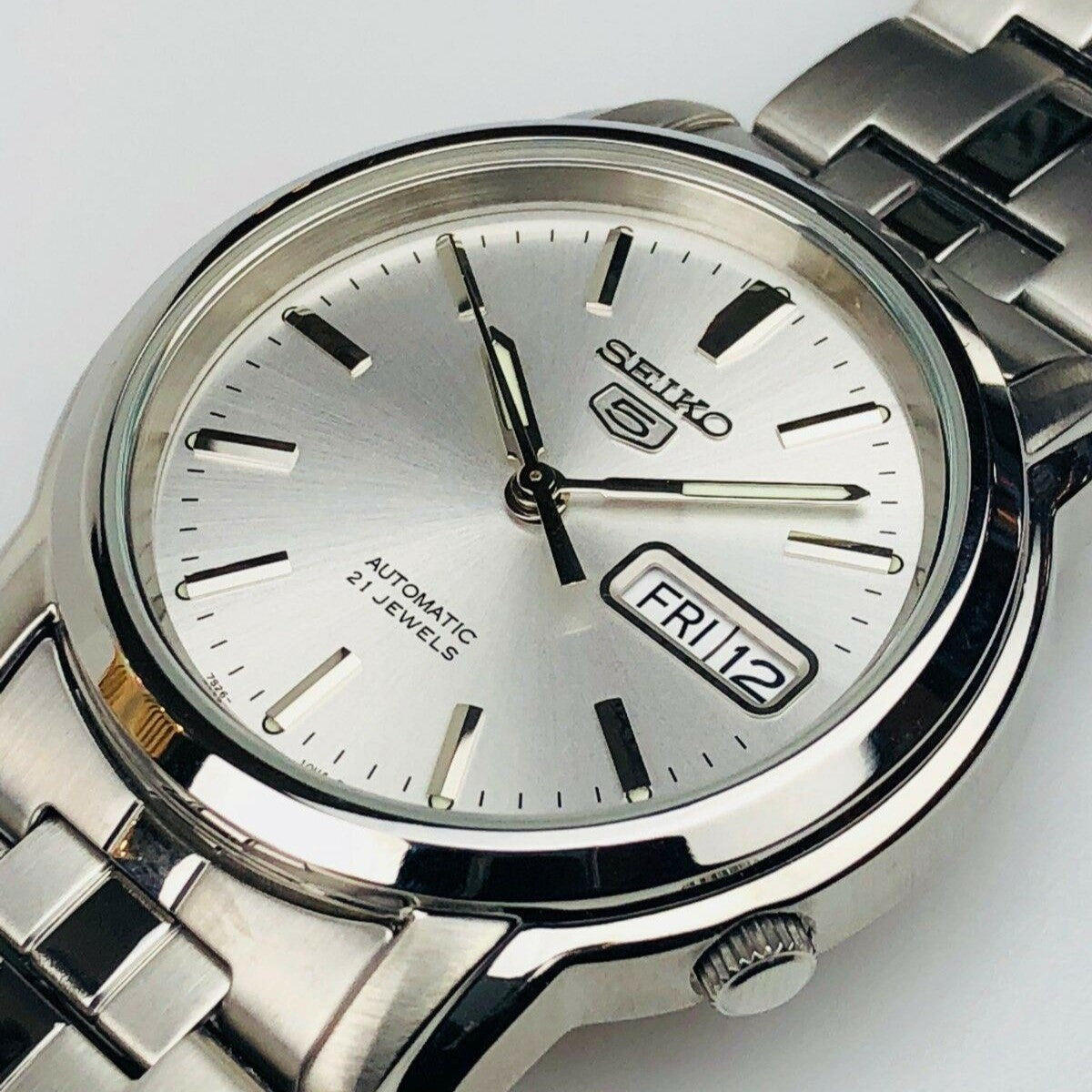 Men's stainless steel automatic watch with silver dial and black hour markers, date window