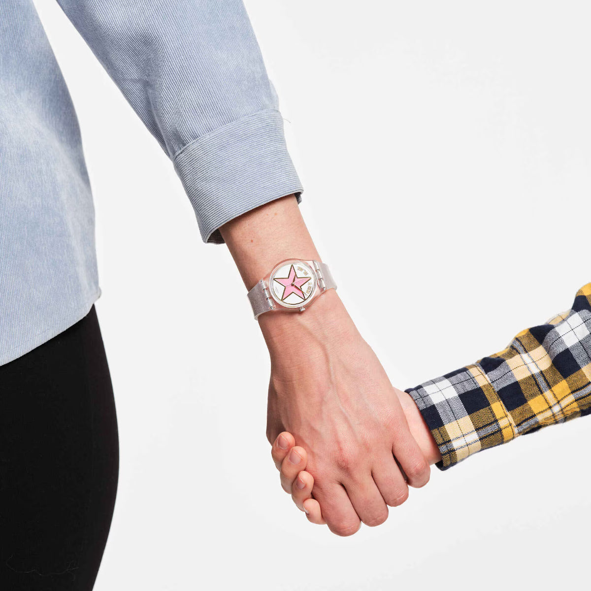 Ladies wristwatch with pink star dial and light gray silicone strap on hand