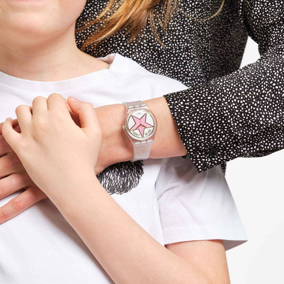 Ladies wristwatch close-up with pink star dial and speckled light silicone strap