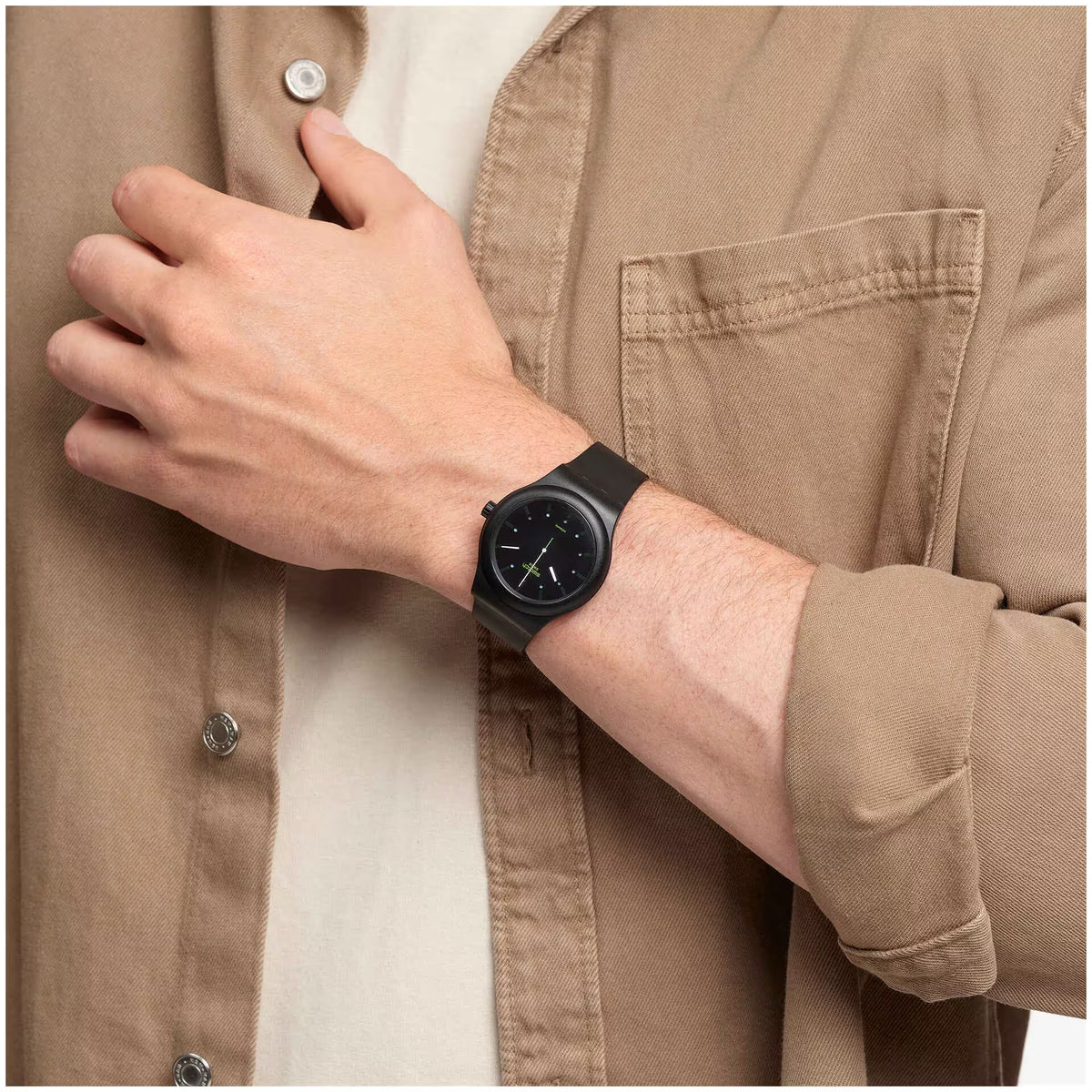 Black automatic wrist watch on a wrist, round black dial with rubber strap