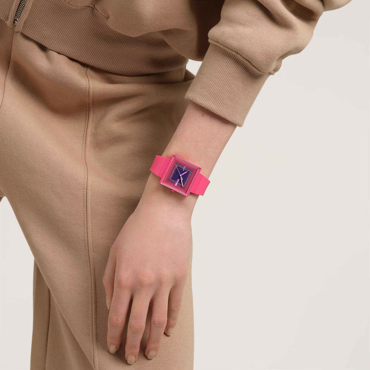 Square berry pink dial watch on wrist with pink silicone strap