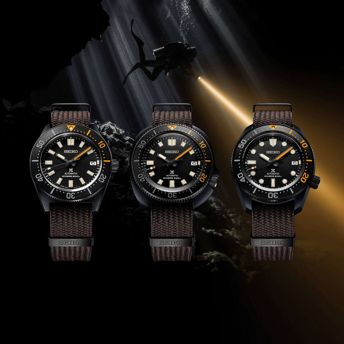 Three Seiko men's diver wristwatches with black dials and brown textile straps