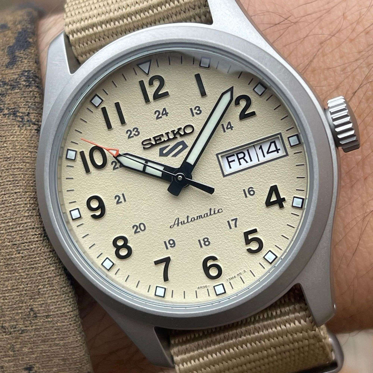 Seiko 5 Sports men's automatic watch: beige dial, date window, beige nylon strap