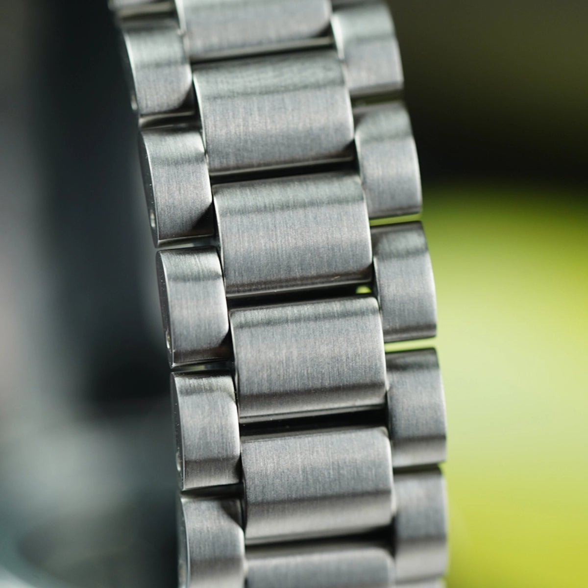Detail shot of the brushed stainless steel links of the Seiko 5 Sports SNXS series watch bracelet.