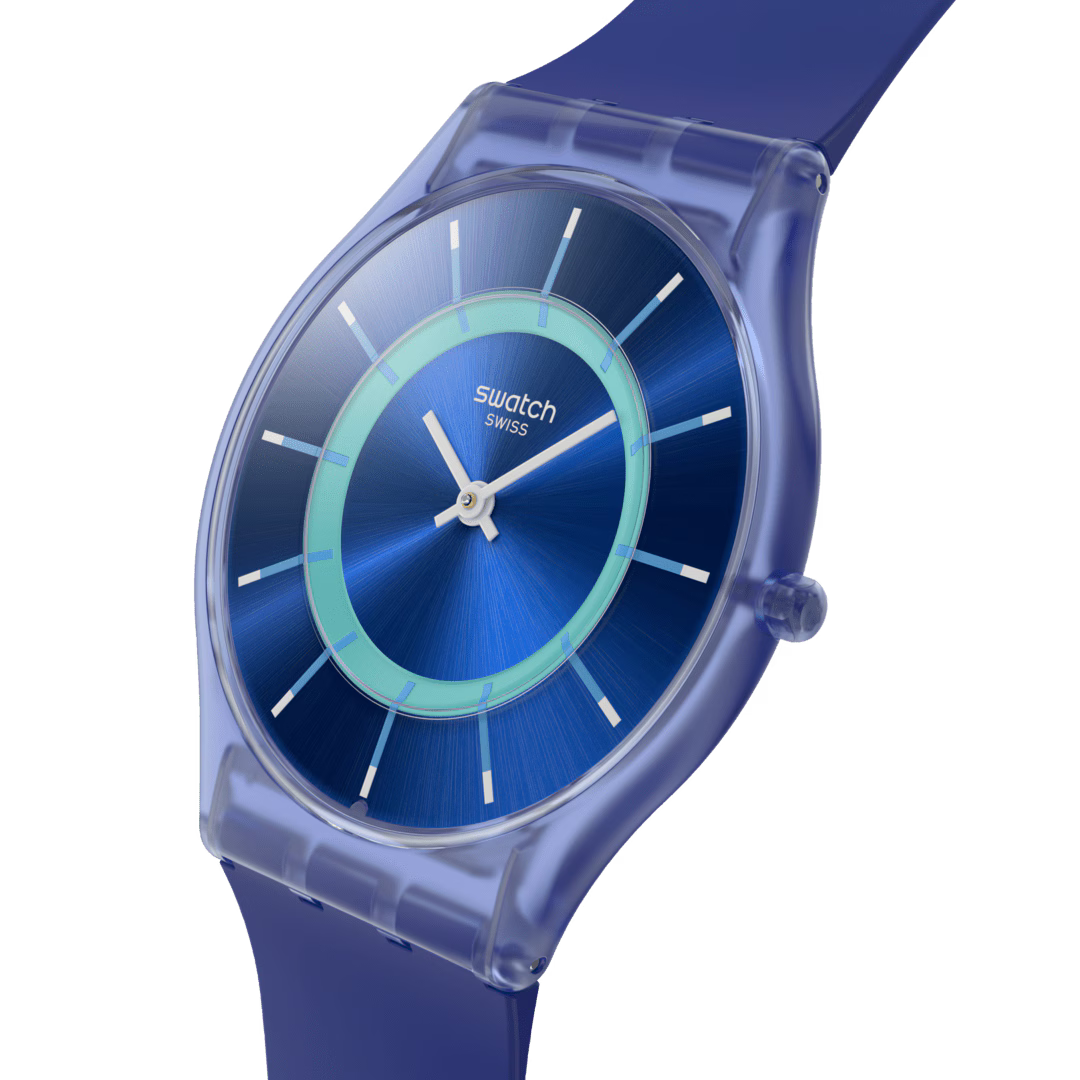 Blue silicone strap Swatch watch close-up, blue dial with light blue ring and markers