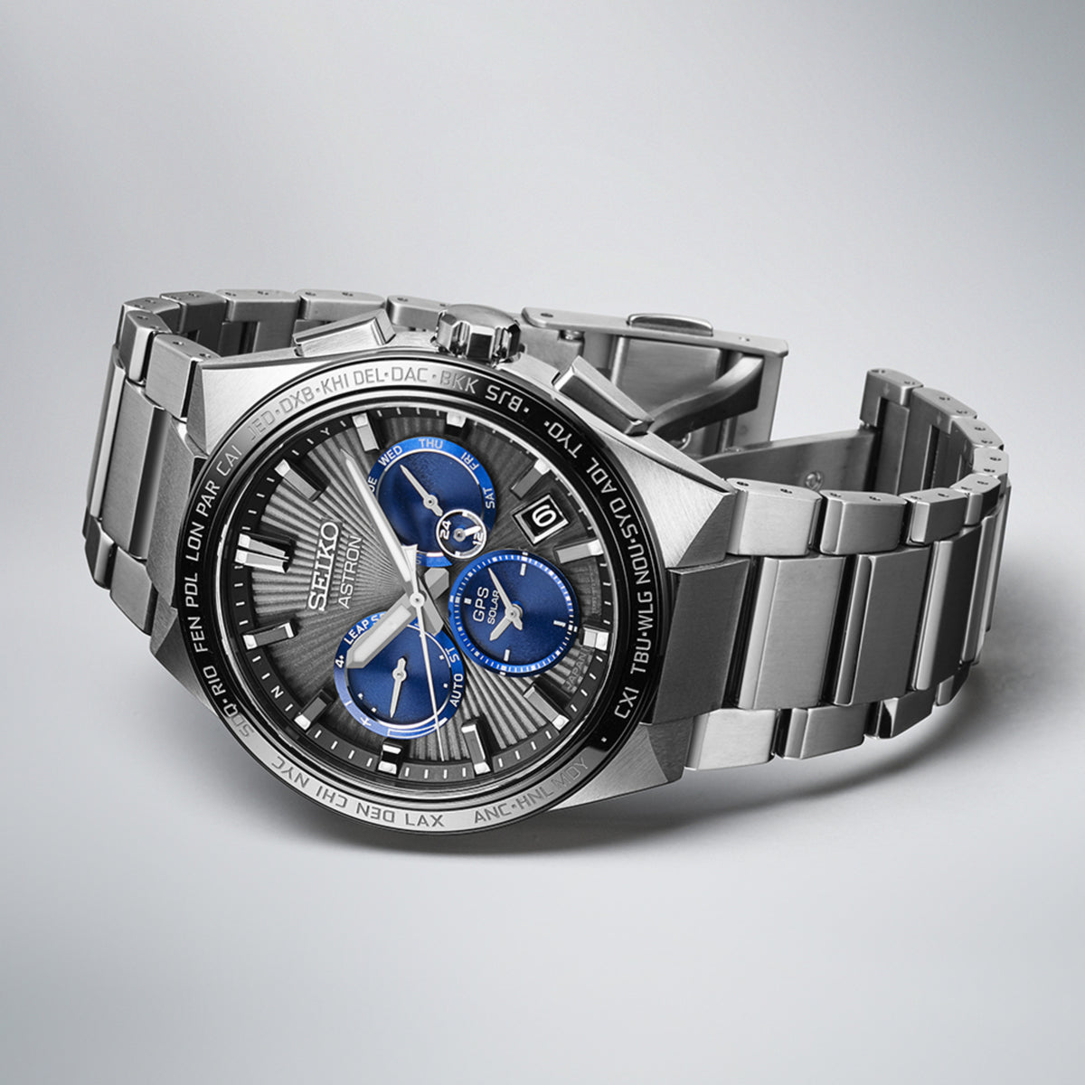 Seiko Astron SSH119J1 watch with blue accents on a gray background