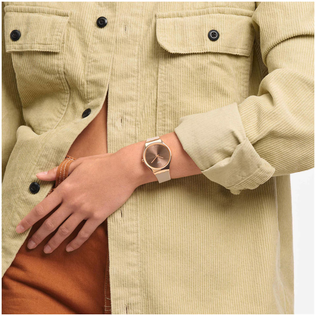 Ladies silicone strap watch on wrist, pink dial with rose-gold bezel