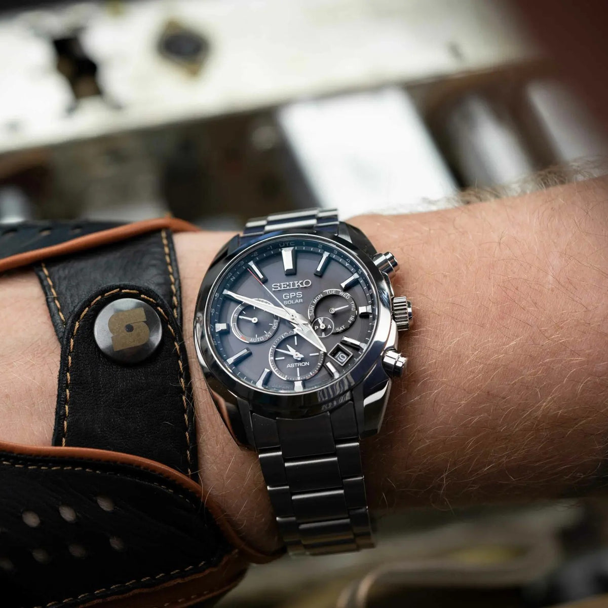 Men's Seiko GPS Solar watch worn on wrist, black dial and stainless steel bracelet