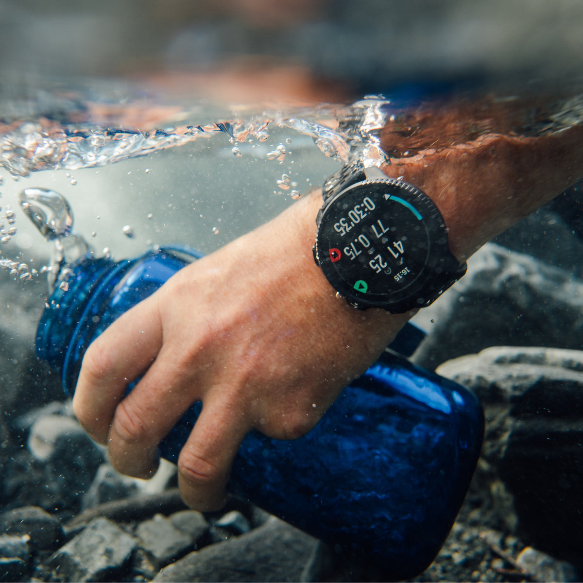 Waterproof Suunto GPS watch submerged under clear water showing active timer and heart rate