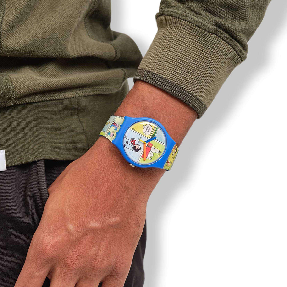 Blue Snoopy silicone strap watch on wrist over green long-sleeve