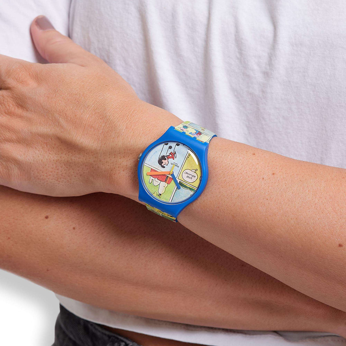 Blue silicone strap wristwatch with Snoopy comic dial on bare arm