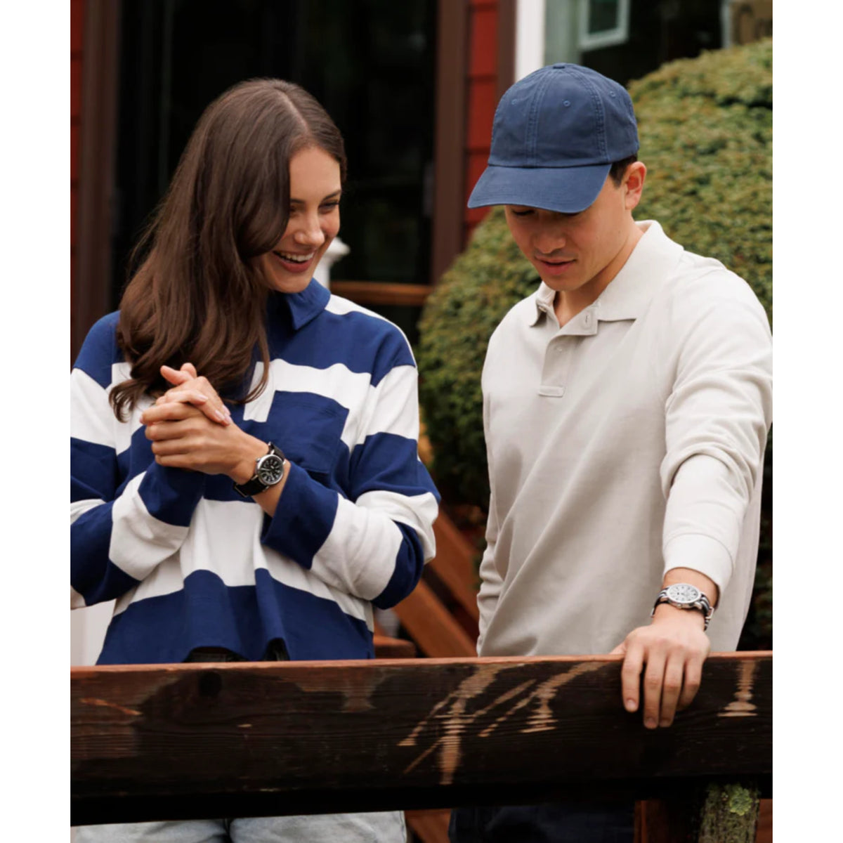 Pair wearing watches: black dial fabric watch on the right man’s wrist