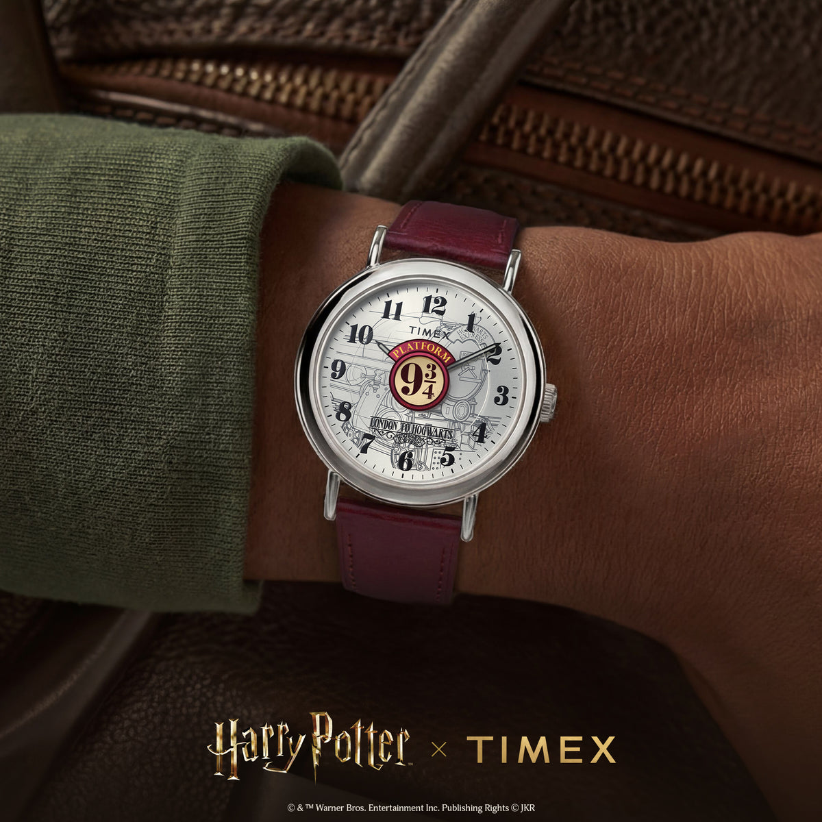 Men's quartz watch on wrist, burgundy leather strap and white dial with 9¾ emblem