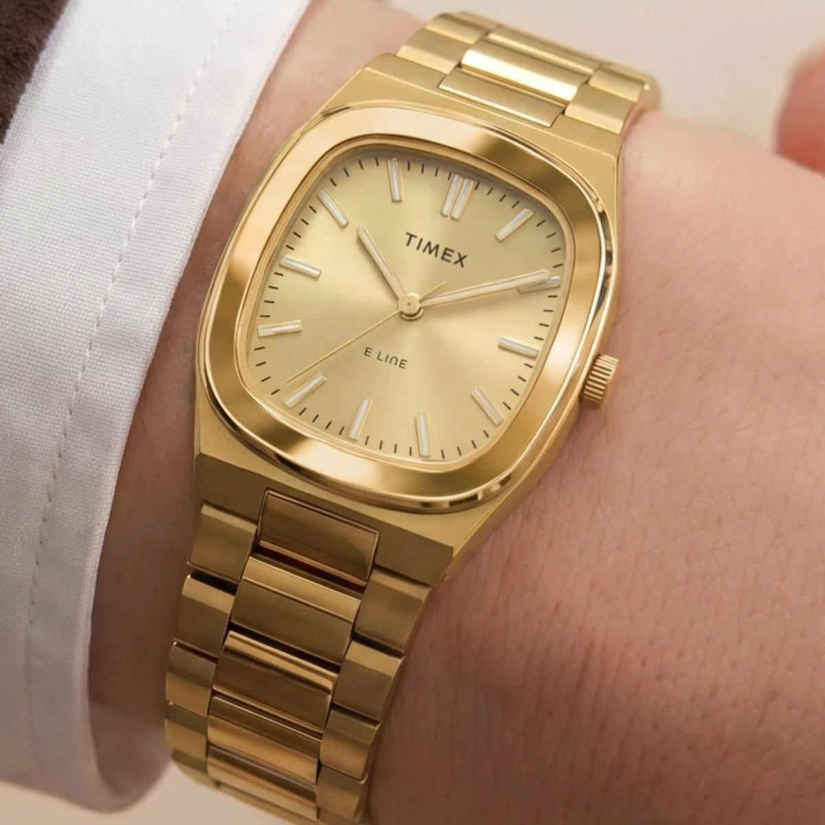 Timex E Line TW6A00900 wrist view showing champagne dial ladies watch styled on a person wearing a yellow gold-tone steel bracelet