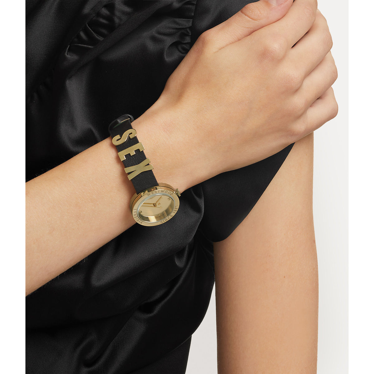 Vivienne Westwood VV303BKGD on-wrist perspective showing black leather strap with gold lettering