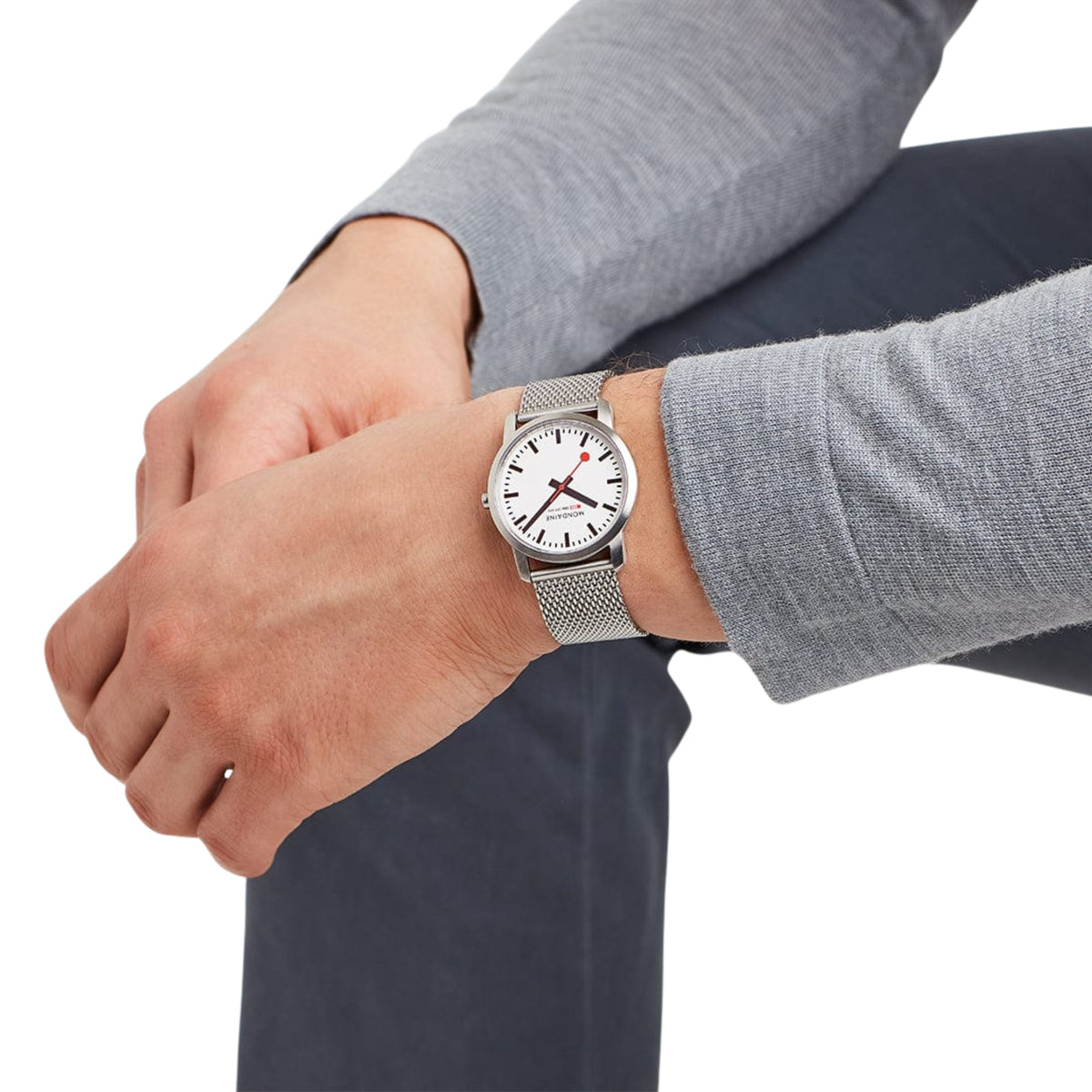 Mondaine Simply Elegant A400.30351.16SBZ quartz timepiece on a male wrist showing the white face and silver mesh strap