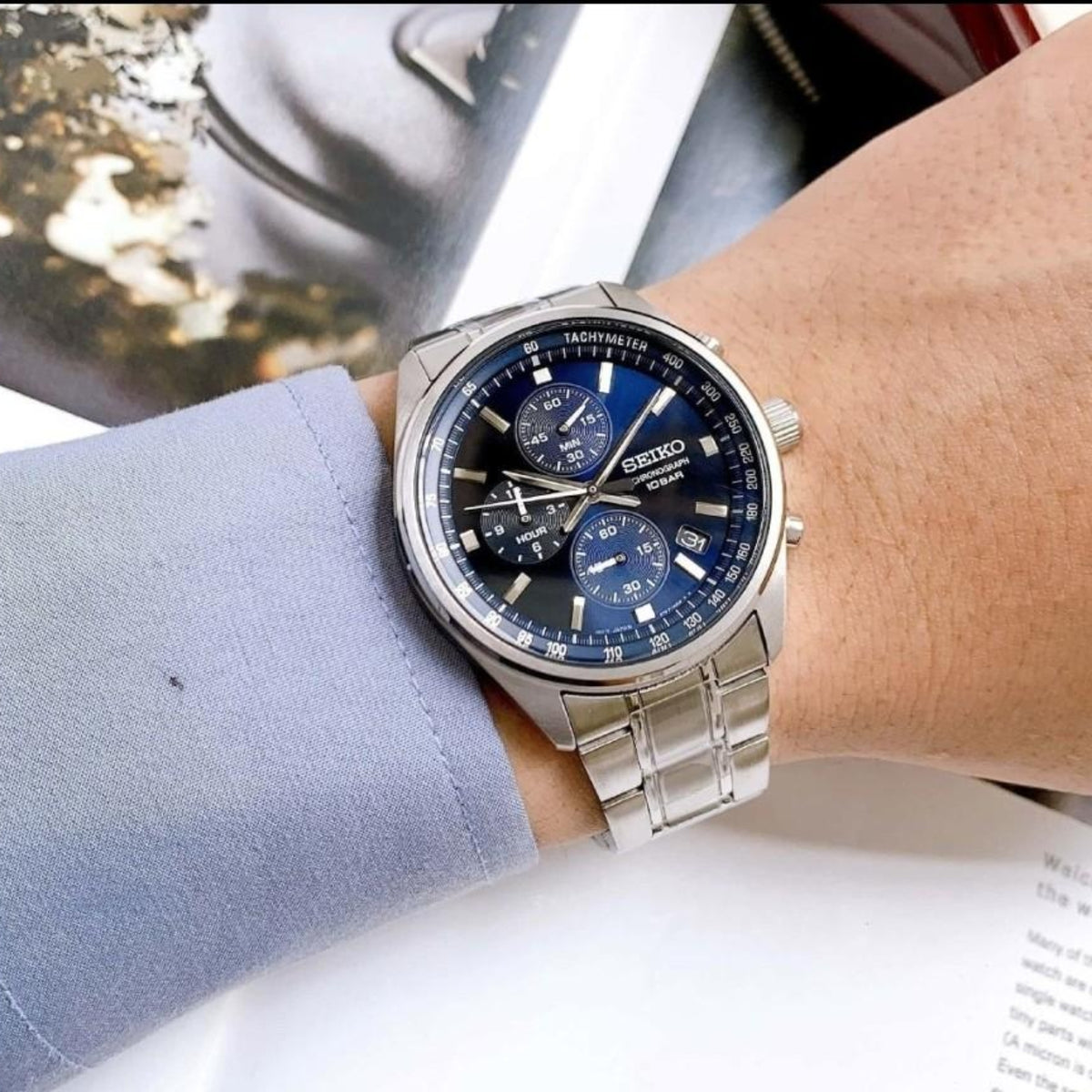 Stainless steel chronograph watch with blue dial, three subdials, link bracelet