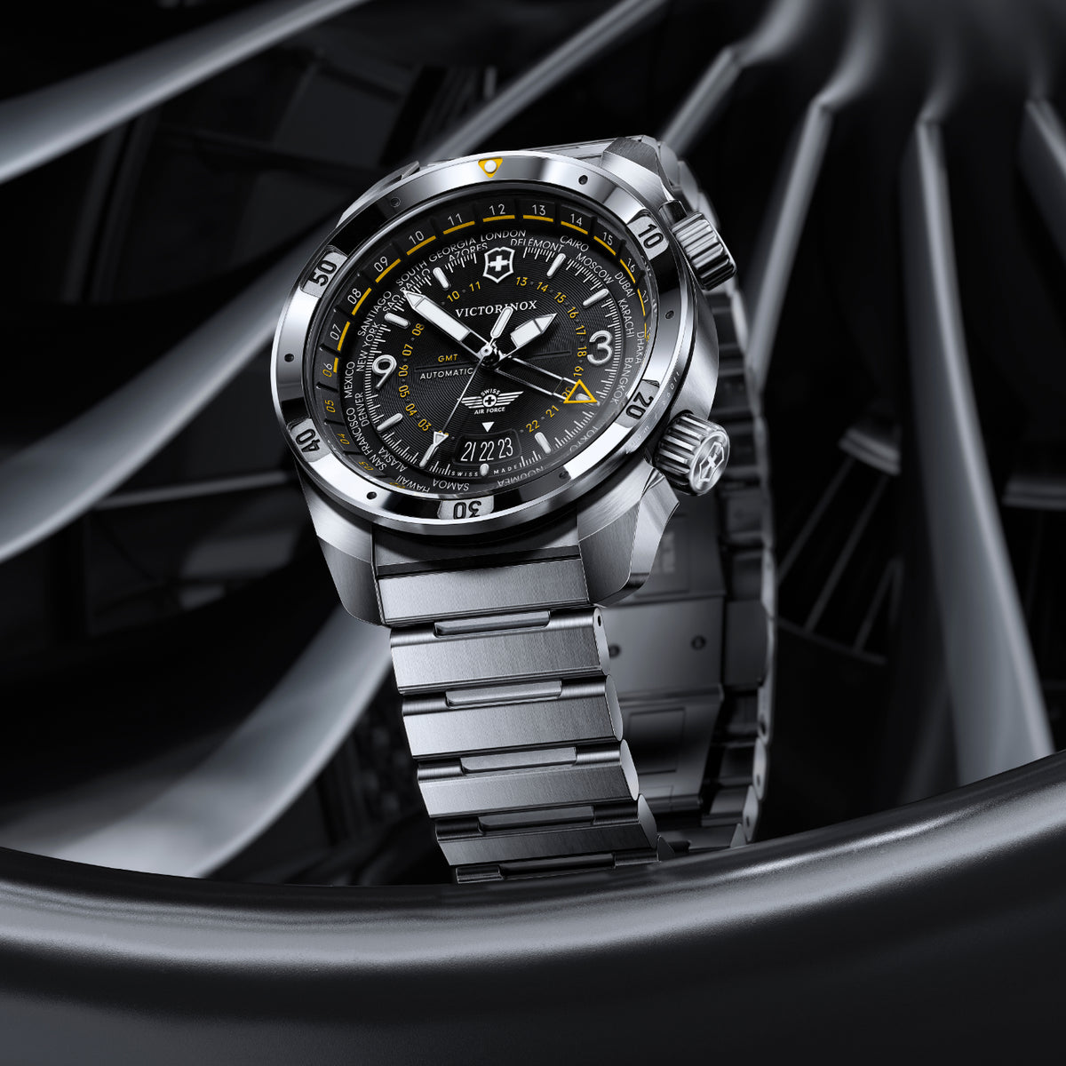 Victorinox GMT world timer automatic watch with black dial, yellow accents, and world cities bezel