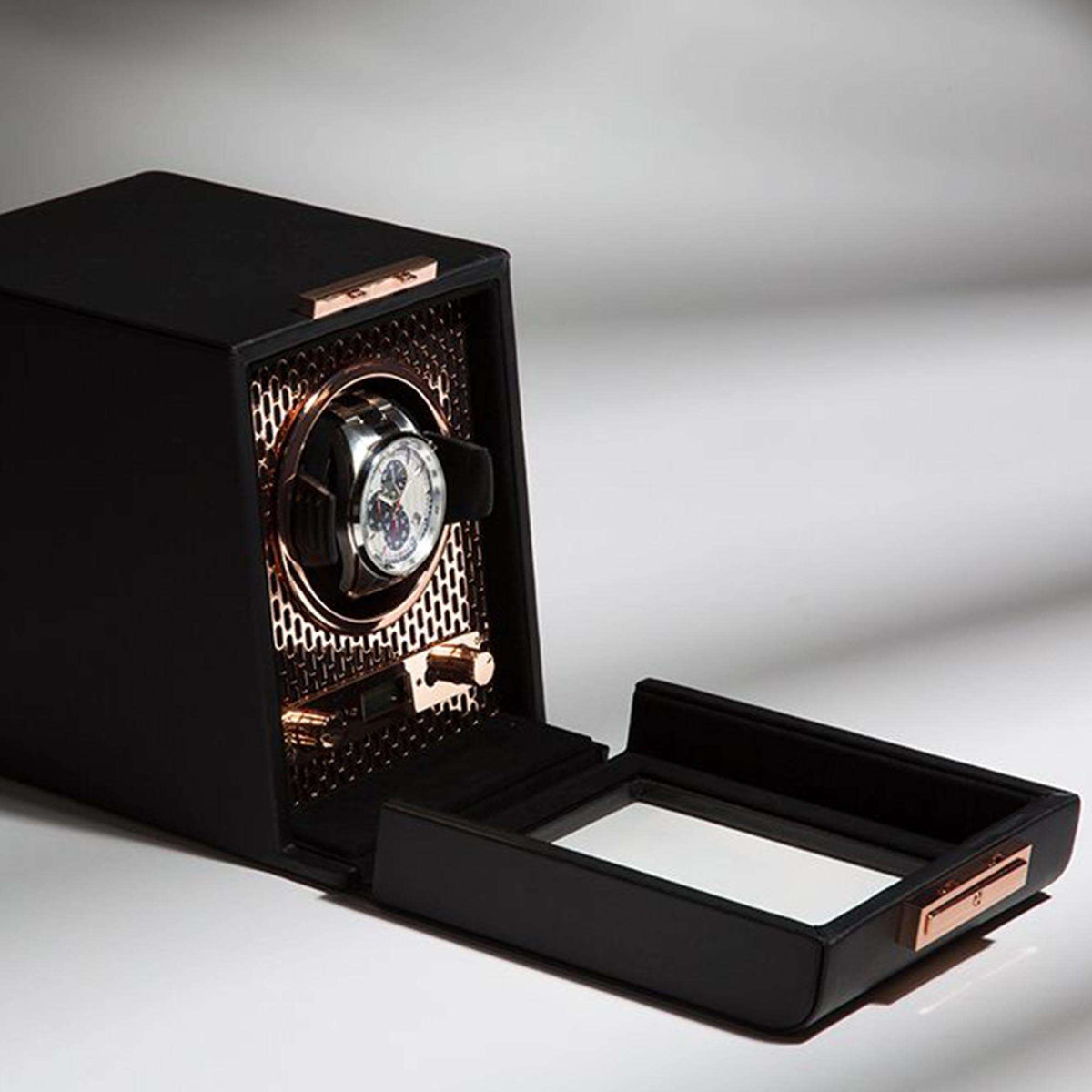Single watch winder open with black tray, copper dial, and patterned side