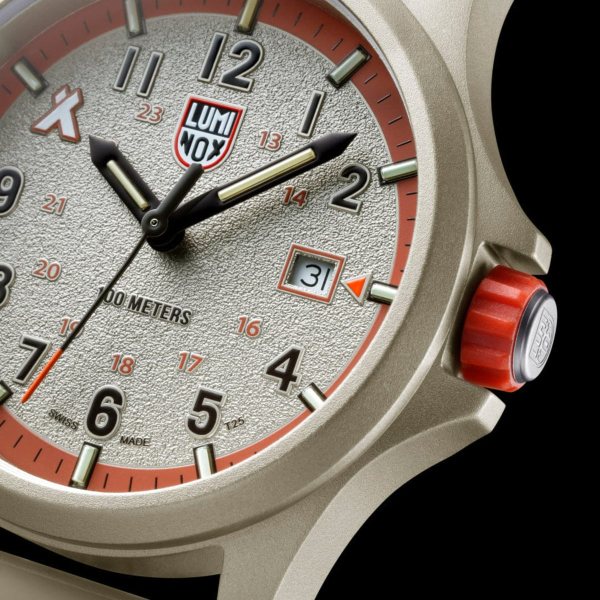 Extreme close-up of the sand-grained dial, date aperture, and orange crown on the Luminox Bear Grylls Survival XB.3717